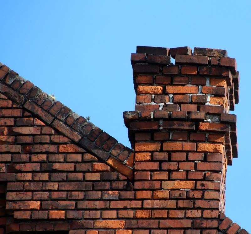 Blog Article - Damaged chimney on an Northville home showing cracks and missing mortar